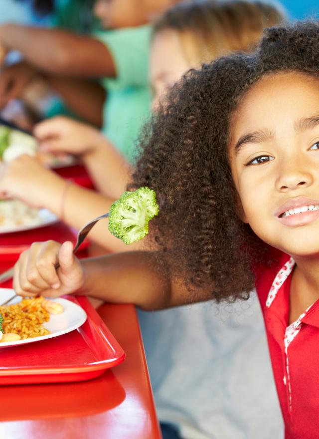 girl eating broccoli